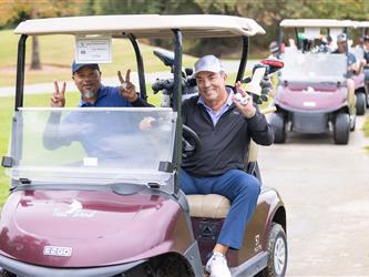players driving golf cart