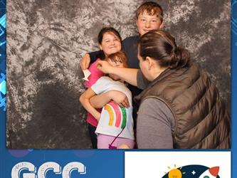family posing for photobooth
