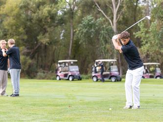 golf player swinging club