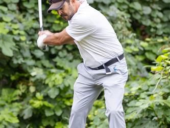 golf player swinging club