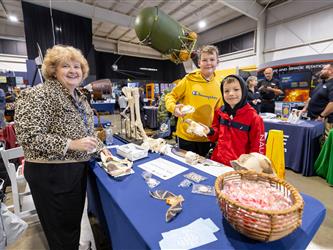 career fair attendees interacting with vendor