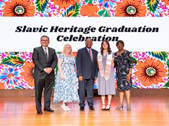 recipient posing with gcc staff on stage