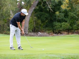 golf attendee teeing off