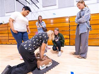 Attendee learning how to perform CPR