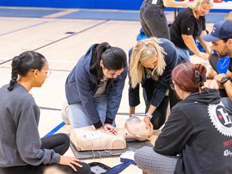 Attendee learning how to perform CPR