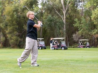 golf player swinging club