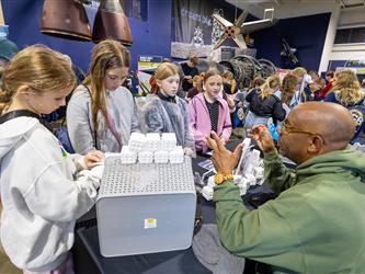 career fair attendees interacting with vendor