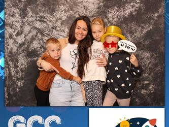 family posing for photobooth