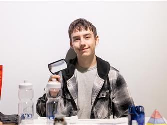 student posed at table