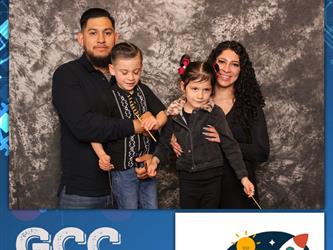 family posing for photobooth