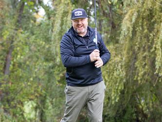 golf attendee teeing off