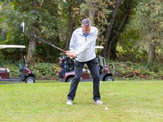 golf player swinging club
