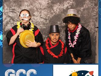 three guests posing for photo booth