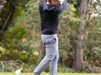 golf player swinging club