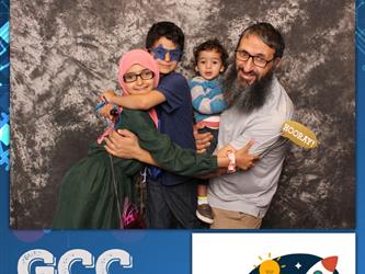family posing for photobooth