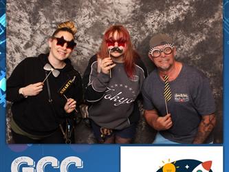 three people posing with props 