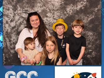 family posing for photobooth