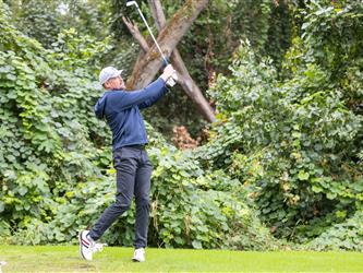golf player swinging club