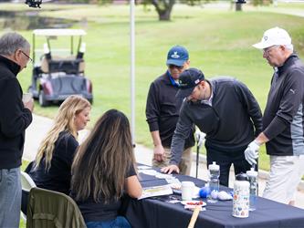 attendees signing form at table
