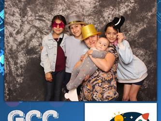 family posing for photobooth