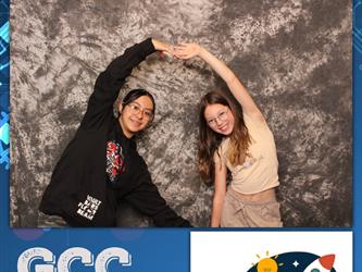two girls making a heart with arms 