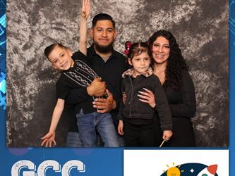 family posing for photobooth