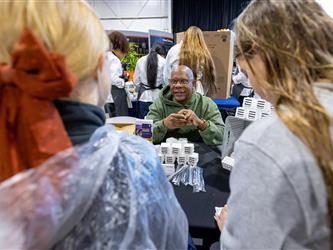 career fair attendees interacting with vendor