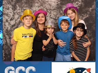 family posing for photobooth