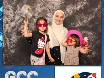 family posing for photobooth