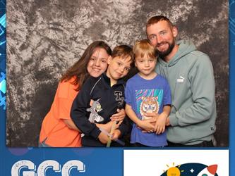 family posing for photobooth