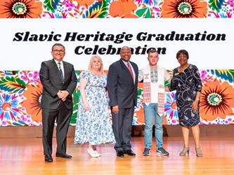 recipient posing with gcc staff on stage