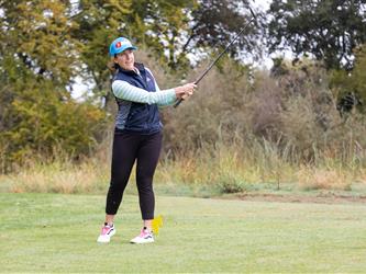 golf player swinging club