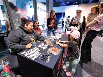 staff engaging with guests at booth 