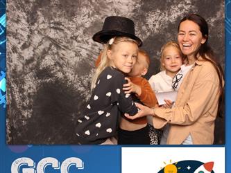 family posing for photobooth