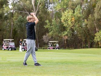 golf player swinging club