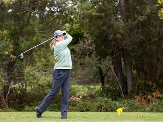 golf player swinging club