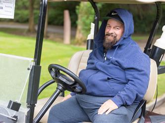 player driving golf cart