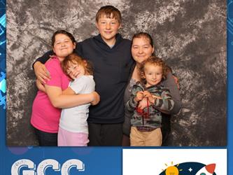 family posing for photobooth