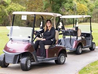 players driving golf cart