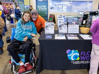 attendees posing at booth