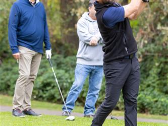 golf player swinging club
