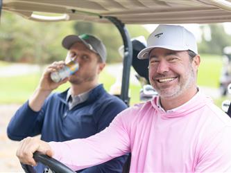 player driving golf cart