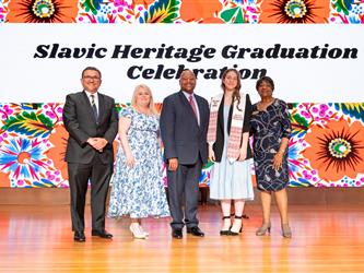 recipient posing with gcc staff on stage