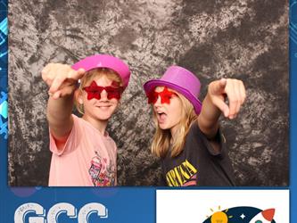 two kids pointing at camera