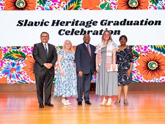 recipient posing with gcc staff on stage