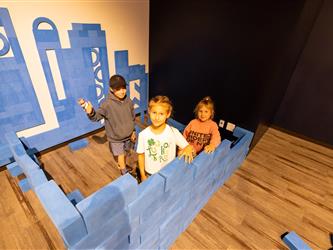 child playing with lego wall 