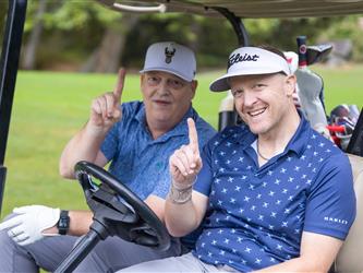 players driving golf cart