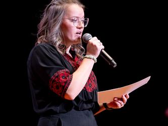speaker holding mic on stage