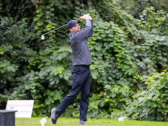 golf player swinging club