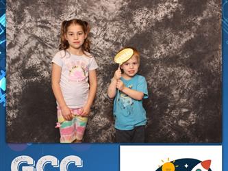 siblings posing for photo booth